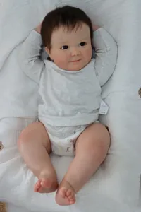 Detailed view of the 60cm reborn baby doll featuring 3D realistic skin and brown hair