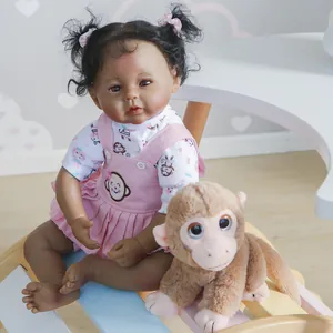 50cm dark skin reborn doll with curly black hair, pink overall dress and plush monkey toy