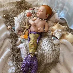 Lifelike 25-inch Rhynn Merbaby reborn doll kit with ginger hair and purple mermaid tail