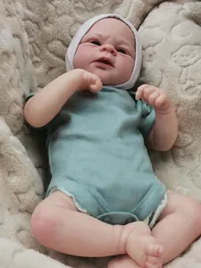 Close-up of lifelike 3D painted reborn baby doll Elijah in soft blue bodysuit