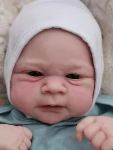 Macro close-up of realistic newborn baby doll face with detailed 3D skin and knit cap
