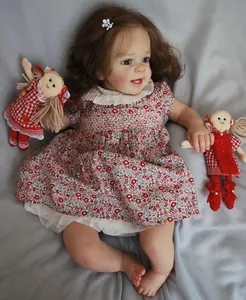 Detailed view of handmade reborn doll Yannik with curly hair and floral doll dress