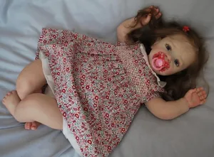 Close-up of lifelike 60cm reborn doll with realistic skin texture and floral dress
