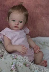 Close-up of realistic newborn doll's face with bright eyes and detailed soft skin texture