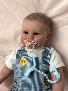 Detailed close-up of 60cm reborn baby doll with realistic skin and blue stripe overalls