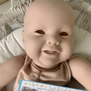 24-inch DIY reborn baby doll kit with realistic smiling head and vinyl limbs in a cradle