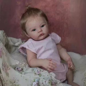 Realistic 18 inch newborn baby doll with blue eyes, blonde hair and pink romper