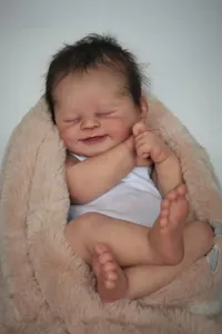 Close-up of Alisha reborn doll showing realistic skin texture and dark brown hair