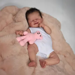 Lifelike 19 inch reborn baby doll Alisha in white romper with a pink crochet bear