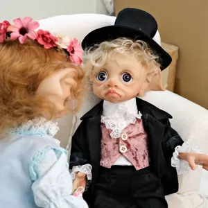 Detailed view of handmade 17 inch elf dolls in formal suits and flower crown