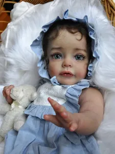 Detail of 60cm lifelike reborn baby doll with blue eyes in a blue dress and wicker basket