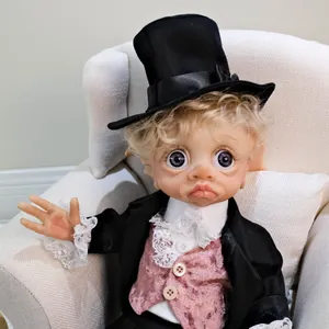 Detailed close-up of 17 inch elf baby doll wearing a black hat and lace velvet suit