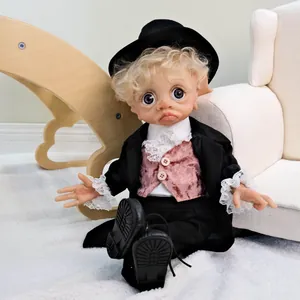 Detail of 17 inch elf doll with curly hair wearing a stylish black suit and hat