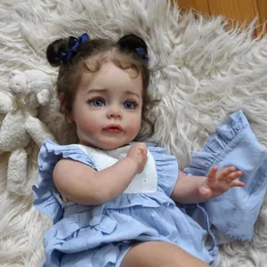 Realistic 60cm reborn baby doll with blue eyes and brown curls in a blue dress
