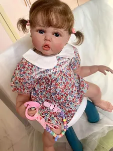 Close-up of 60cm reborn doll with 3D skin texture, floral dress, and pink pacifier
