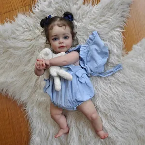60cm realistic reborn baby doll with blue eyes and brown curls on plush white rug