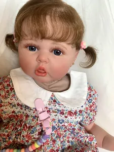 Close-up of 60cm reborn doll with detailed 3D skin texture and floral dress
