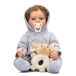 Close-up of Yannik reborn doll with brown curly hair holding an elephant plush toy