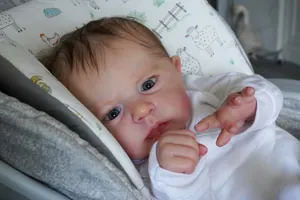 Detailed close-up of 60cm reborn baby doll with realistic 3D skin texture and veins