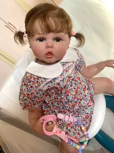 Detailed view of reborn doll with brown curls, floral dress and colorful pacifier chain