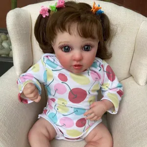 Close-up of 45cm reborn baby doll with brown hair, blue eyes and 3D skin texture