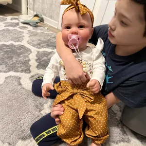 60cm realistic reborn baby doll Kodi with 3D skin and veins held by a person