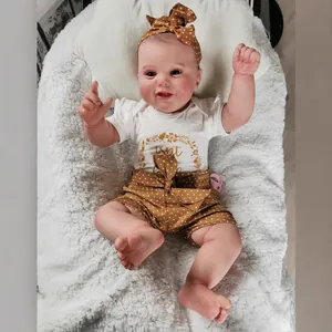 Lifelike 60cm reborn baby girl doll with 3D skin and visible veins in floral outfit