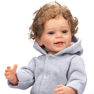 Lifelike 55cm Reborn baby doll Yannik with blue eyes, curly hair and grey hoodie