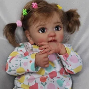 Realistic 45cm reborn doll with brown pigtails, flower clips and fruit print bodysuit