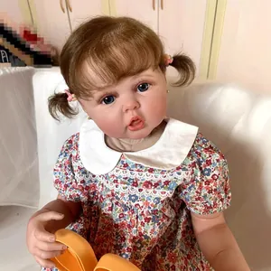 Realistic 60cm baby doll with brown pigtails and 3D skin details in floral dress