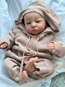Detailed close-up of realistic 3D skin texture on 49cm reborn doll wearing knit romper