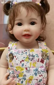 Detail of 55cm realistic reborn doll with daisy hair accessories and floral romper