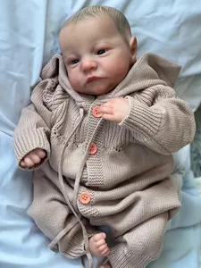 Detail of reborn baby doll Levi with hand-painted 3D skin and pink knitted outfit
