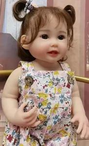 Close-up of a 55cm reborn baby doll with realistic skin texture and cute double buns
