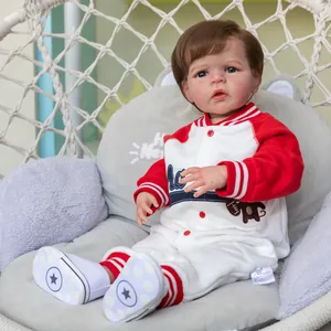 Lifelike 60cm reborn toddler Sandie doll in red baseball outfit on a cozy gray cushion