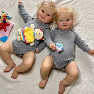 50cm lifelike reborn baby Maddie doll with curly blonde hair and grey ribbed romper suit