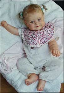 Close-up of lifelike reborn baby doll Maddie with detailed 3D skin texture and floral bib
