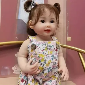 55cm lifelike reborn baby doll Teegan with brown pigtails and pink floral dress