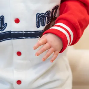 Detailed 60cm lifelike reborn toddler Sandie doll in red and white outfit close-up