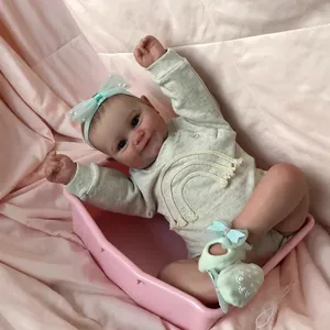 Lifelike 24-inch reborn baby doll with 3D skin and knit rainbow fringe romper outfit