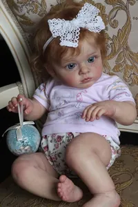Detailed close-up of 60cm reborn doll with realistic freckles and blue eyes