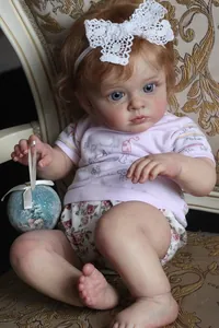 Detail of 60cm reborn doll with 3D skin texture, veins, and floral outfit on chair