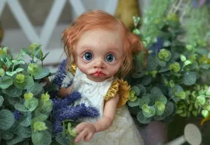 Close-up of 16-inch lifelike elf doll with red curly hair, freckles and blue eyes