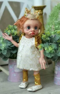 Detailed close-up of handmade elf doll with realistic facial painting and embroidery