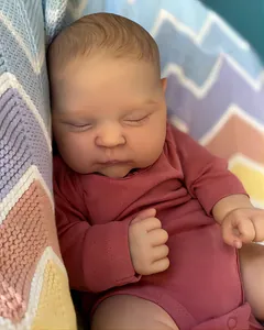 Close-up of sleeping reborn baby doll with 3D hand-painted skin and hair details