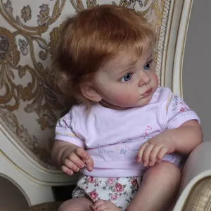 Lifelike 60cm reborn baby doll with 3D skin and blue eyes sitting on a vintage chair