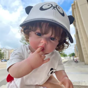 Muñeca bebé reborn realista de 55 cm con pelo castaño y traje de panda al aire libre