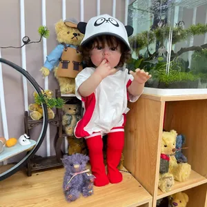Muñeca bebé reborn de 55 cm con gorro de panda y pelo rizado en una acogedora habitación