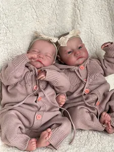Detailed view of twin reborn baby dolls with realistic skin textures on soft white rug