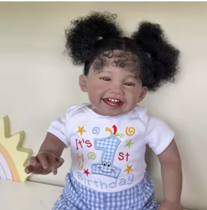 Detail of 60cm reborn baby Mila doll in birthday outfit with curly pigtails
